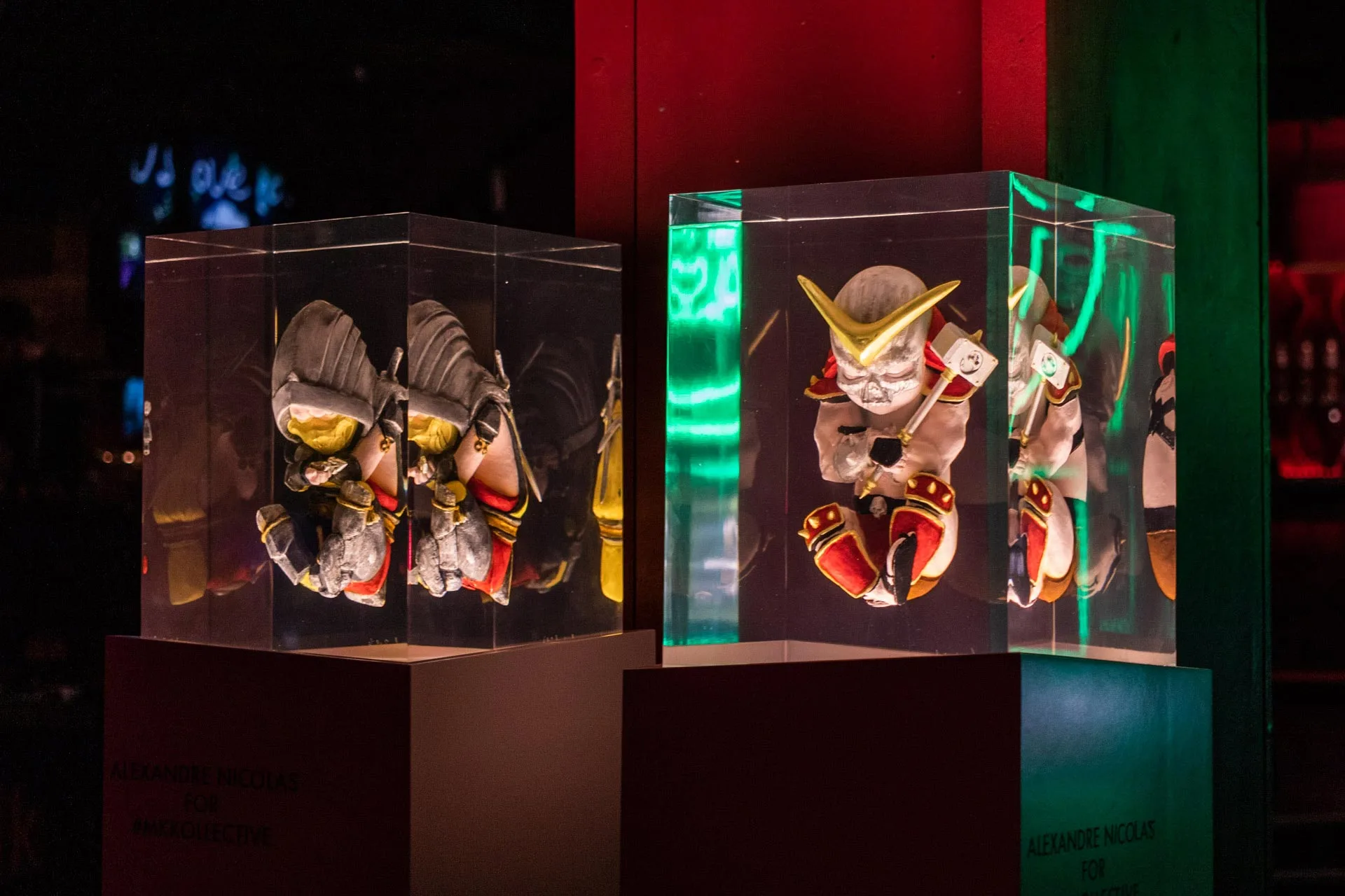 Characters cast in resin blocks, lit in red and green on the set