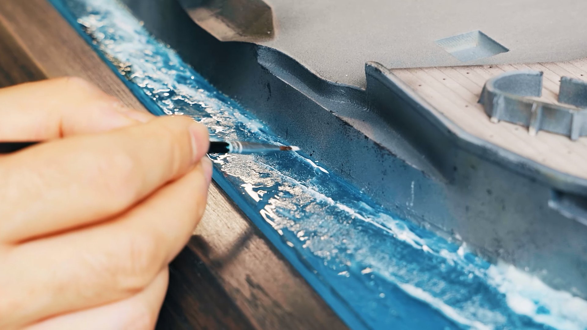 Hand-painting the acrylic ocean waves